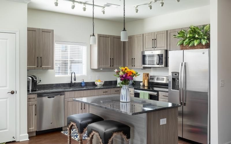 a kitchen with an island and chairs